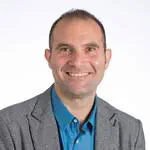 Utility-scale and distributed batteries in renewables-dominated power systems: experiences and lessons learnt from Australia